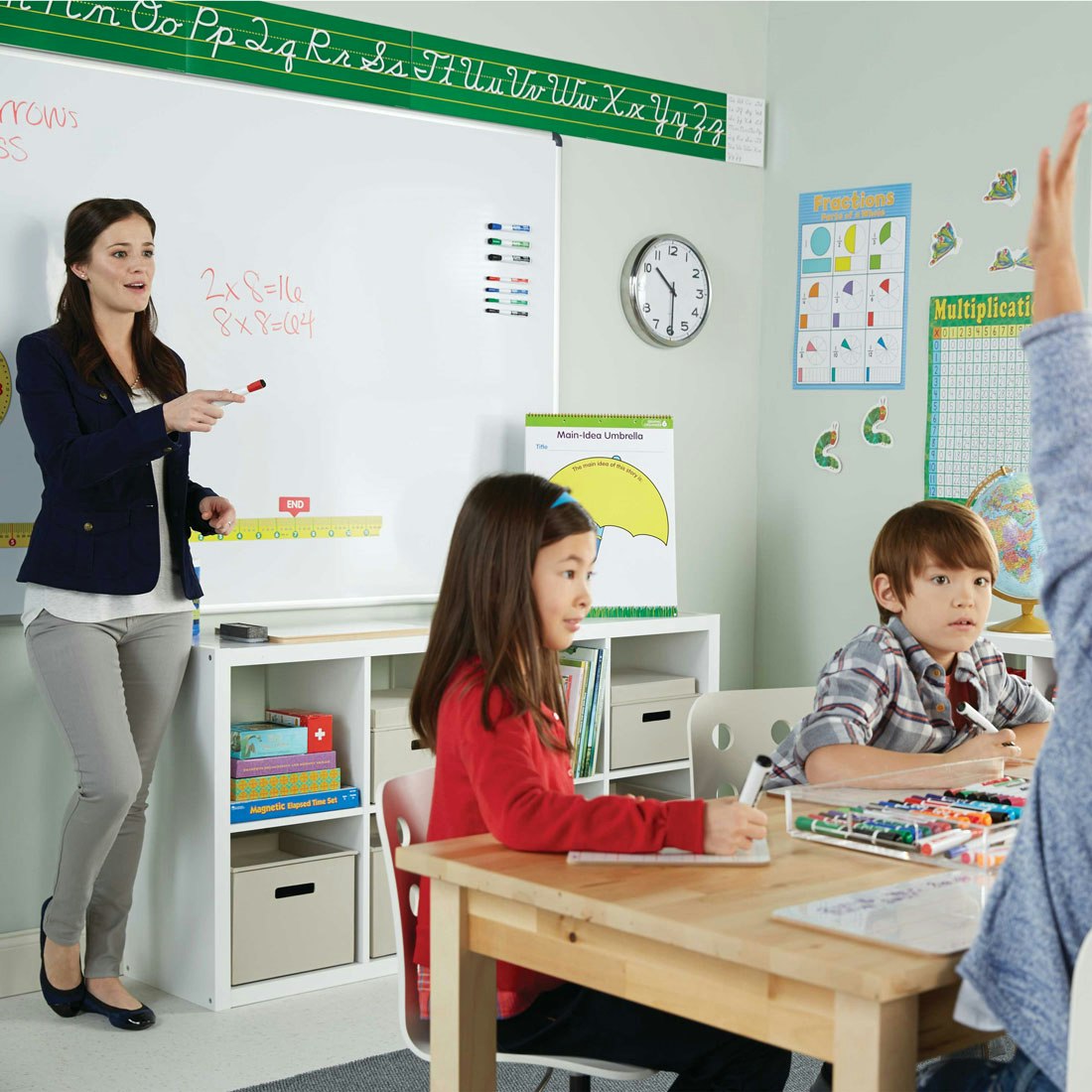 teacher-in-front-of-class-at-board-with-expo-marker