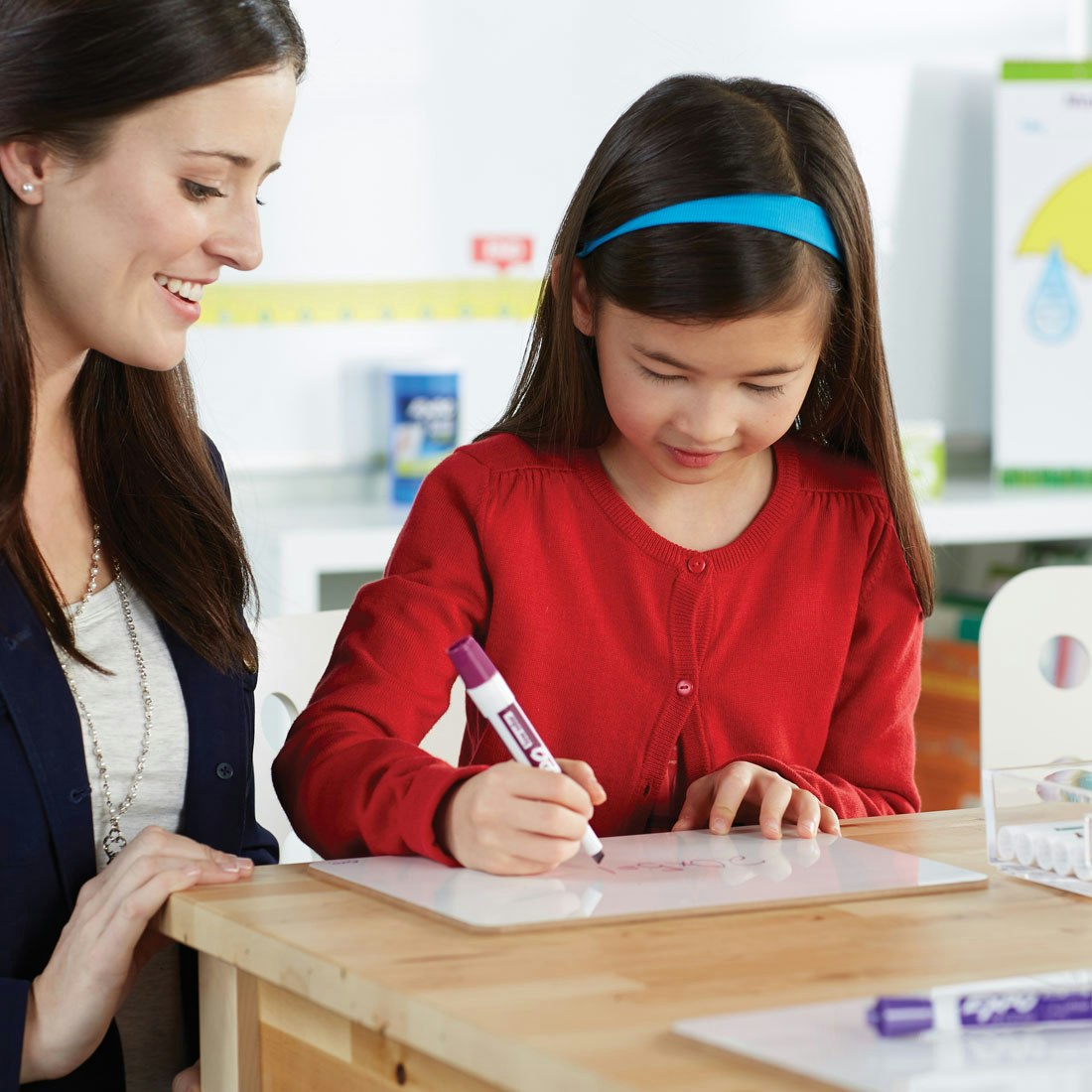 student-writing-on-individual-whiteboard-with-purple-chisel-expo-marker.jpg