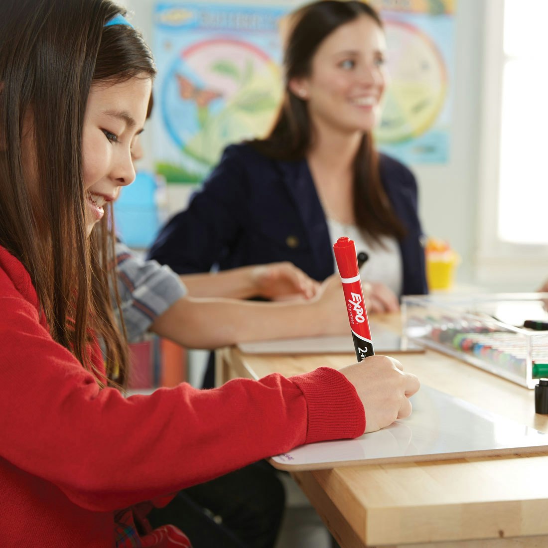 student-working-on-individual-whiteboard-with-expo-2in1-marker.jpg