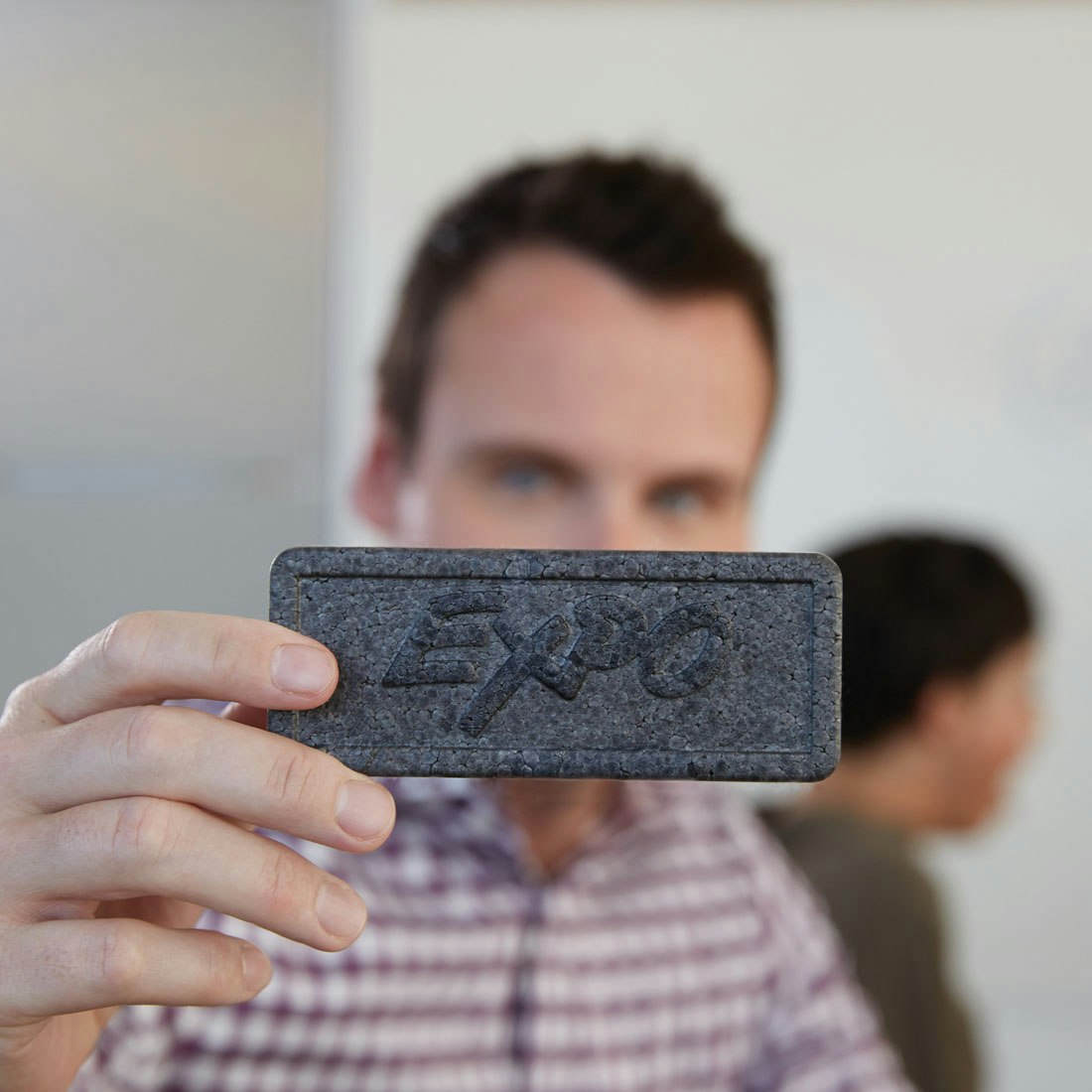 man-holding-up-expo-eraser.jpg
